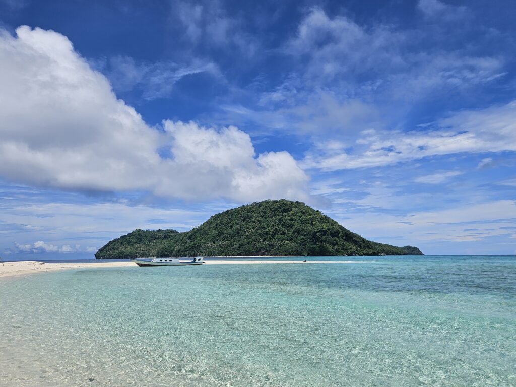 The boat floating in front of Pulau Ay at the Banda Islands in Indonesia