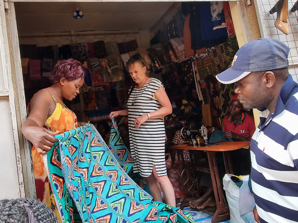 Fred Masaba and a client of Elgon Safaris Uganda at a fabric store in Uganda to see what fabrics Uganda has to offer