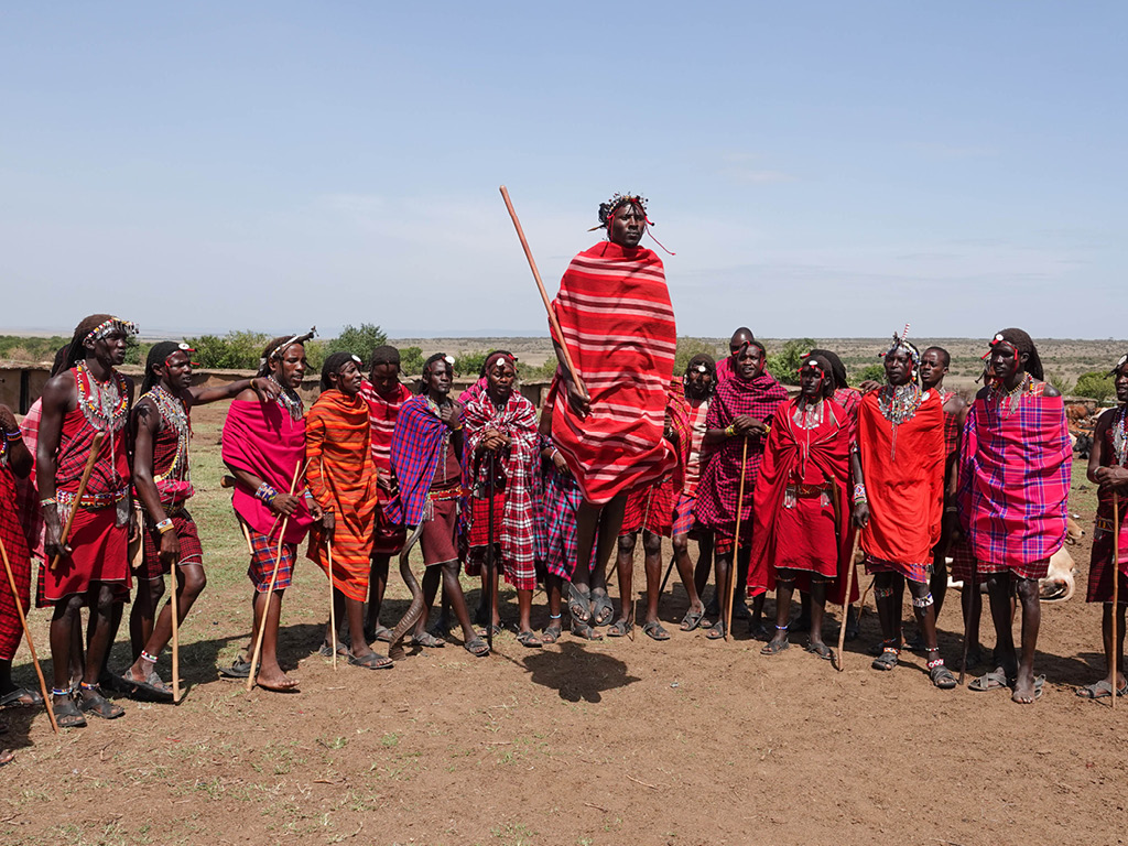 A group of Masai men at their village in the Masai Mara jumping as part of their culture