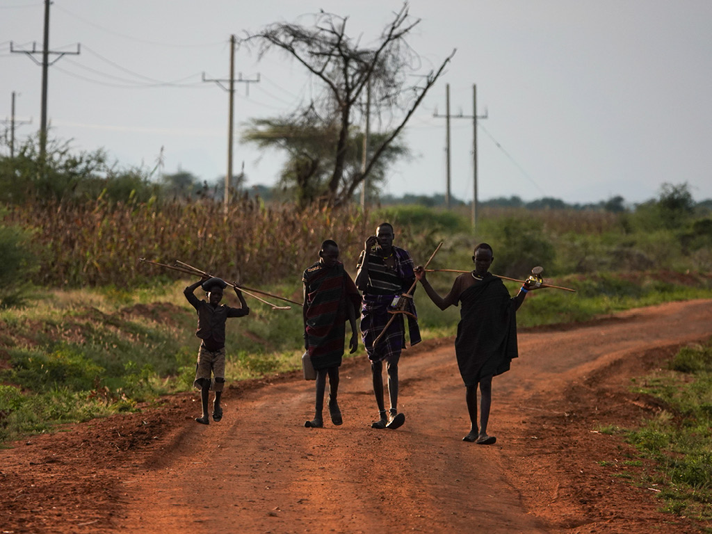 Karamajong walking on the road near Kidepo Valley National Park