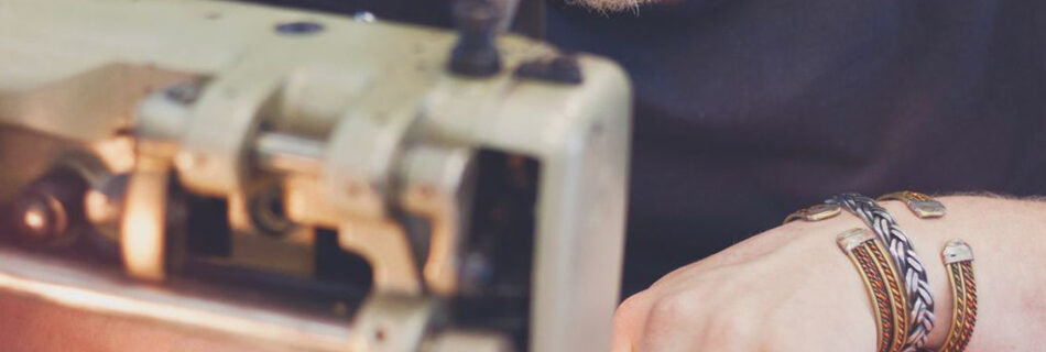 Jan Boelo sitting behind his sewing machine